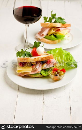 photo of delicious toast stuffed with cheese and ham with lettuce and parsley