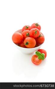 photo of delicious tomatoes inside a bowl on white isolated background