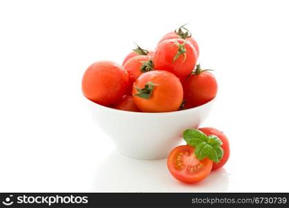 photo of delicious tomatoes inside a bowl on white isolated background
