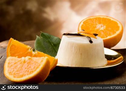 photo of delicious vanilla orange pudding on golden plate