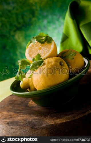 photo of delicious yellow lemon fruit in front of a green background