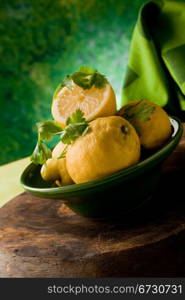 photo of delicious yellow lemon fruit in front of a green background