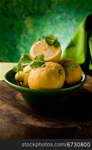 photo of delicious yellow lemon fruit in front of a green background