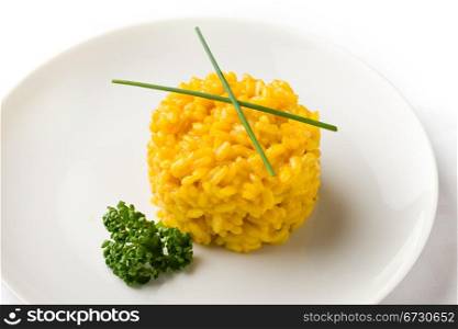 photo of delicious yellow risotto with saffron on white isolated background
