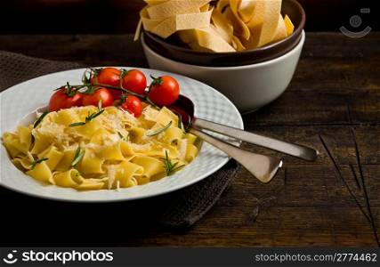 photo of deliciuos pasta with rosemary on rustic wooden table