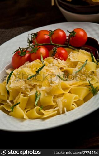photo of deliciuos pasta with rosemary on rustic wooden table