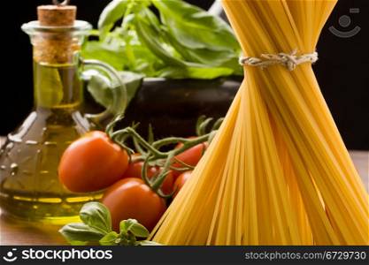 photo of different ingredients for italian pasta with tomatoes and basil