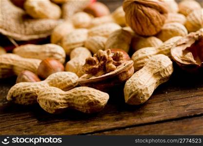 photo of differents nuts inside a cloth on wooden table