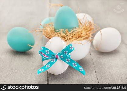 Photo of easter eggs over wooden table