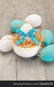 Photo of easter eggs over wooden table