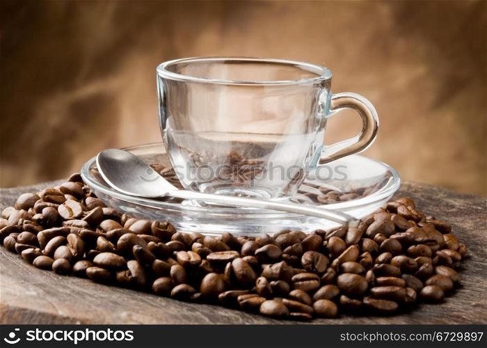 photo of empty glass cup on coffee beans over wooden table