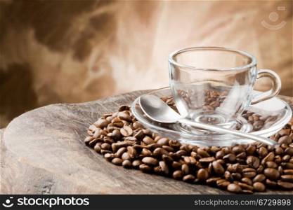 photo of empty glass cup on coffee beans over wooden table