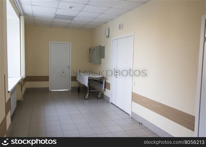 Photo of empty stretcher in hospital corridor