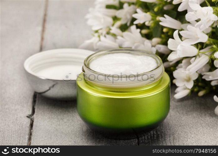 Photo of face cream over wooden table