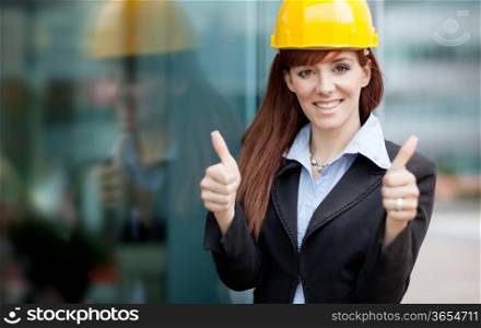 photo of female constructor with blueprints