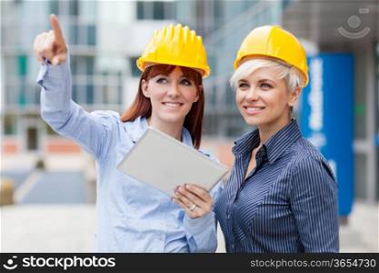 Photo of female constructors discussing their project