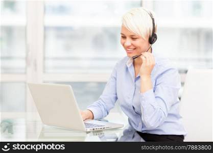 photo of female support assistant working on the computer in the office