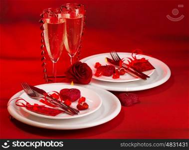 Photo of festive table setting, luxury white dishware on red tablecloth, hearts decorations, beautiful rose flower, two glasses for wine, alcohol drink, romantic date, Valentine day, love concept