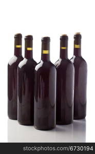 photo of five wine bottles in front of white isolated background