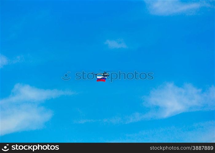 Photo of flying helicopter in blue sky