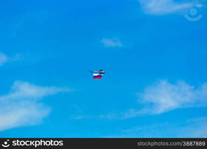 Photo of flying helicopter in blue sky