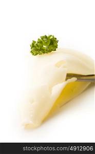 photo of fork with thin slice of cheese with parsley