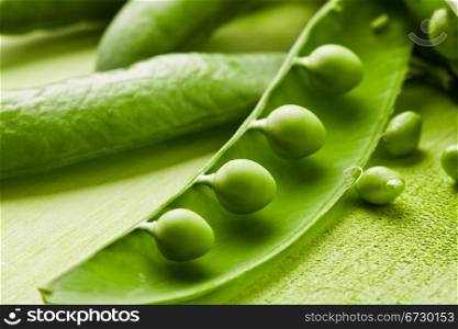 photo of fresh green peas on wooden table