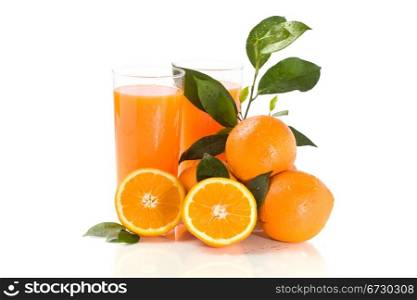 photo of fresh orange juice with water drops and green leaves