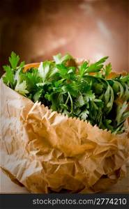 photo of fresh parsley inside a paper bag on wooden table