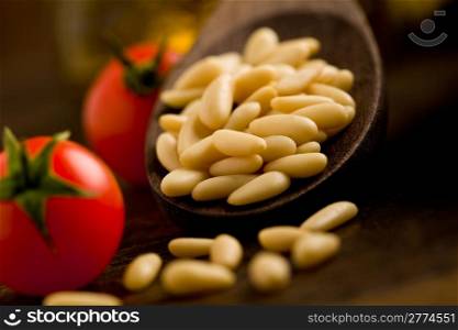 photo of fresh pine nuts close-up on wooden spoon