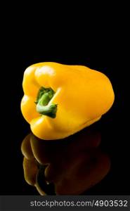 photo of fresh vivid colorful pepper on black background