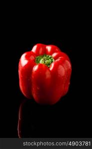 photo of fresh vivid colorful pepper on black background