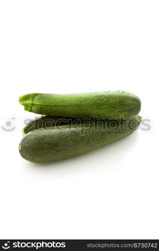 photo of fresh zucchini on white isolated background