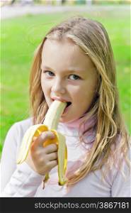 Photo of girl are eating banana in summer
