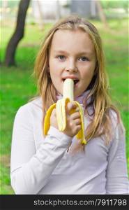 Photo of girl are eating banana in summer