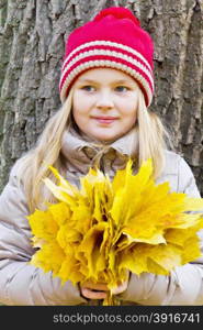 Photo of girl with bouquet from sheets in autumn