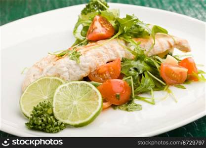 photo of grilled chicken breast with fresh green rocket salad