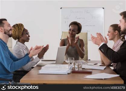Photo of happy business people applauding at meeting focus on boss african girl