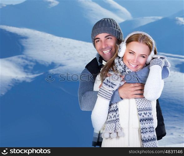 Photo of happy family enjoying winter vacation in snowy mountains, closeup portrait of cheerful smiling couple hugging outdoor in cold weather, romantic date, affection and happiness concept