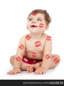 Photo of happy kid covered with red kisses print on the body, adorable baby boy sitting in studio isolated on white background, nice toddler looking up, Valentine day, love concept