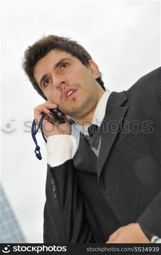 Photo of happy winner businessman talking on mobile phone
