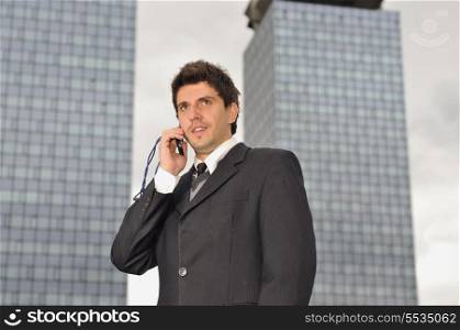 Photo of happy winner businessman talking on mobile phone