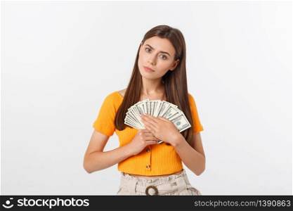 Photo of happy young woman standing isolated over grey background. Looking aside holding money and credit card.. Photo of happy young woman standing isolated over grey background. Looking aside holding money and credit card