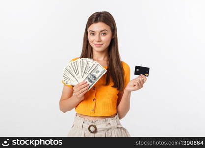 Photo of happy young woman standing isolated over grey background. Looking aside holding money and credit card.. Photo of happy young woman standing isolated over grey background. Looking aside holding money and credit card