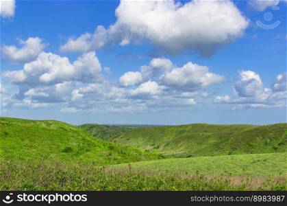 Photo of hills with clouds and blue sky, hills and blue sky with copy space