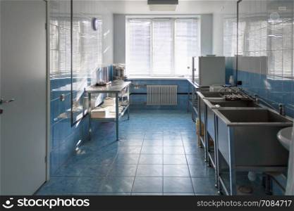 Photo of hospital kitchen with large sinks. Empty hospital kitchen