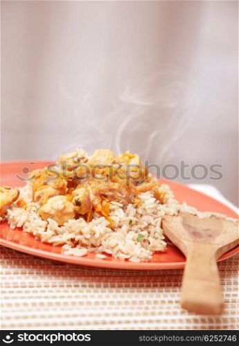 Photo of hot chicken meal with rice, traditional chinese cereal with tasty prepared fish, healthy nutrition, organic food, dinner in restaurant, plate with spicy dish on the kitchen at home