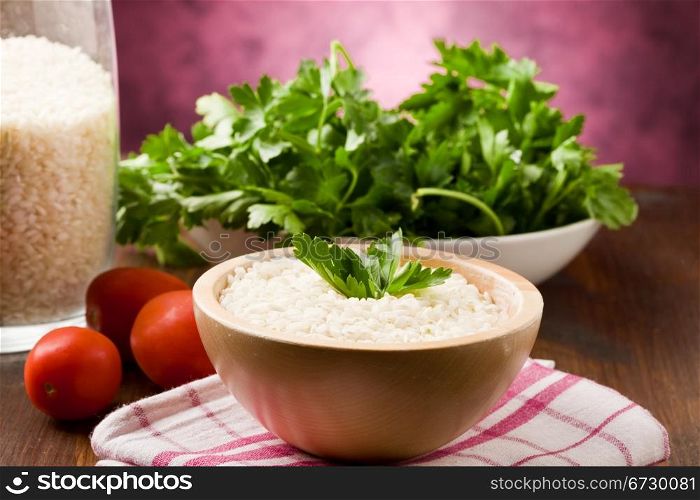 photo of ingredients for risotto with parsley on wooden table