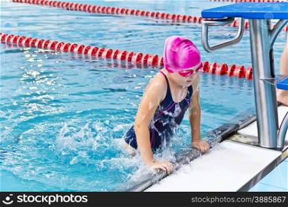 Photo of jumping girl in swimming pool