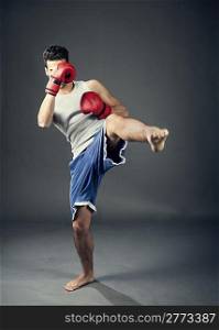 photo of kick boxer hitting with his feet
